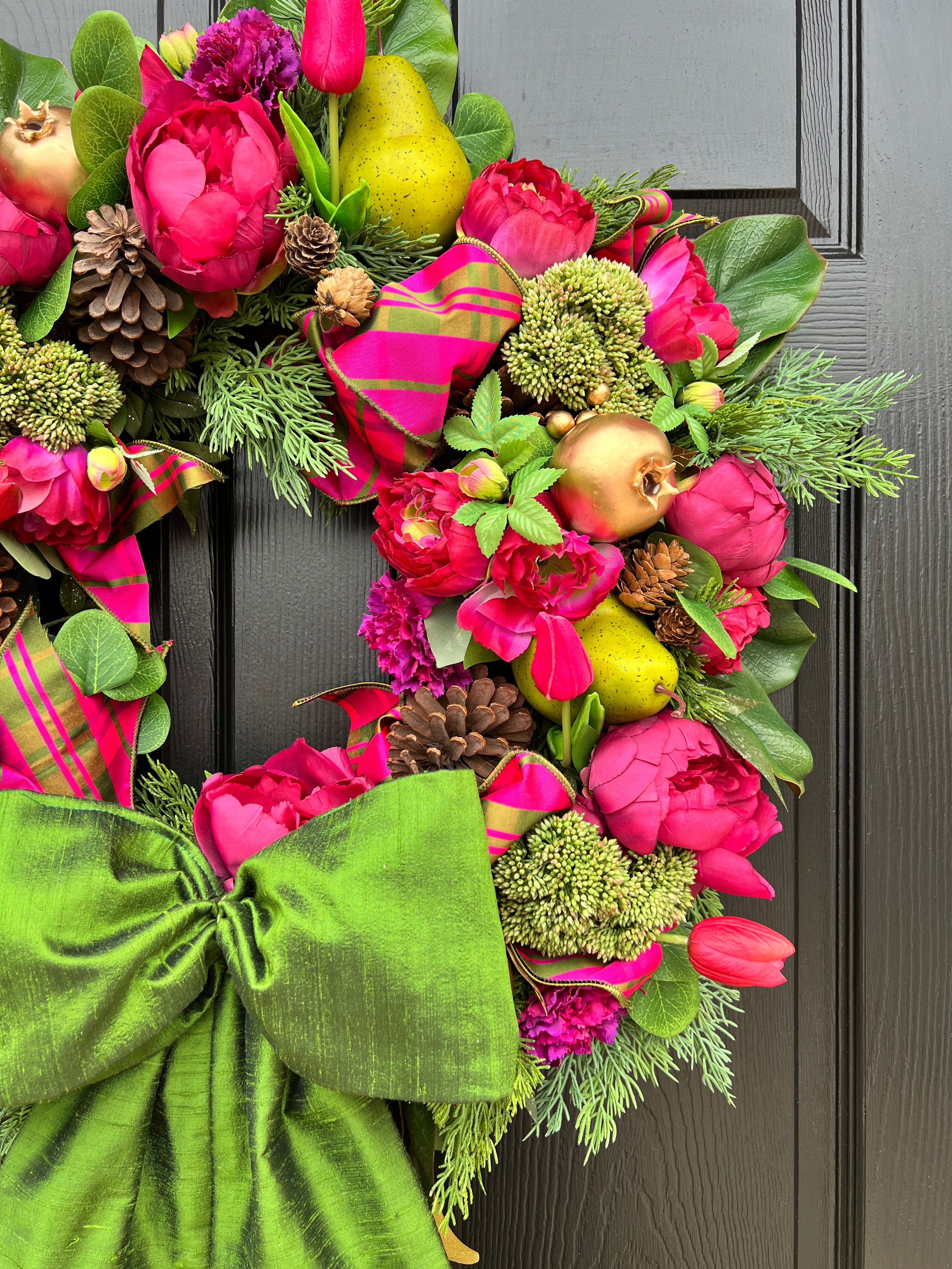 Lush fuchsia and green floral and fruit winter wreath