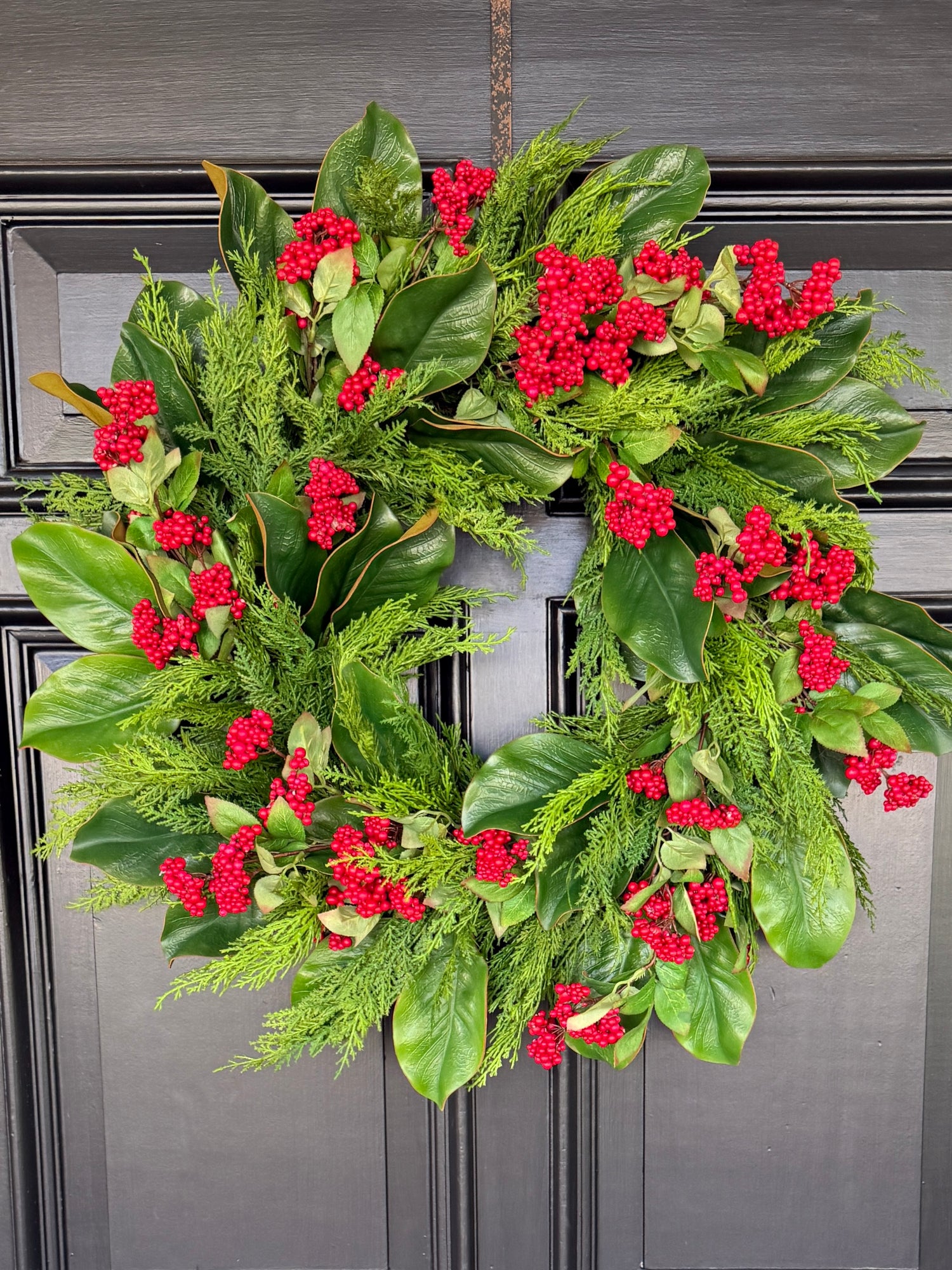Red berry, cedar, and magnolia leaf wreath 27”