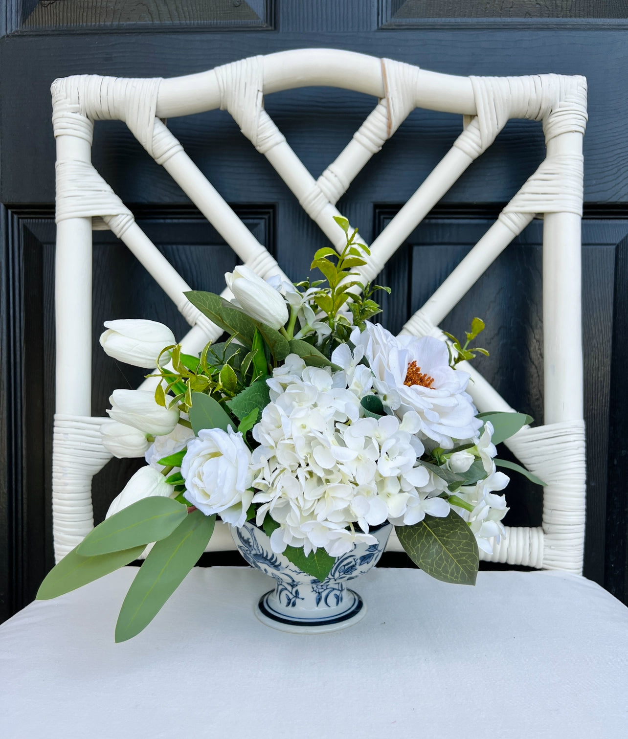 White rose and tulip floral arrangement in chinoiserie footed bowl