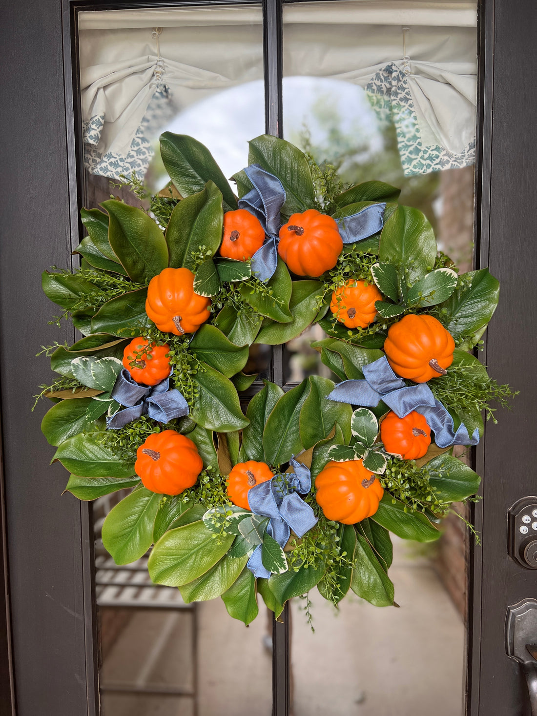 Fall orange pumpkin and magnolia wreath with French blue ribbons