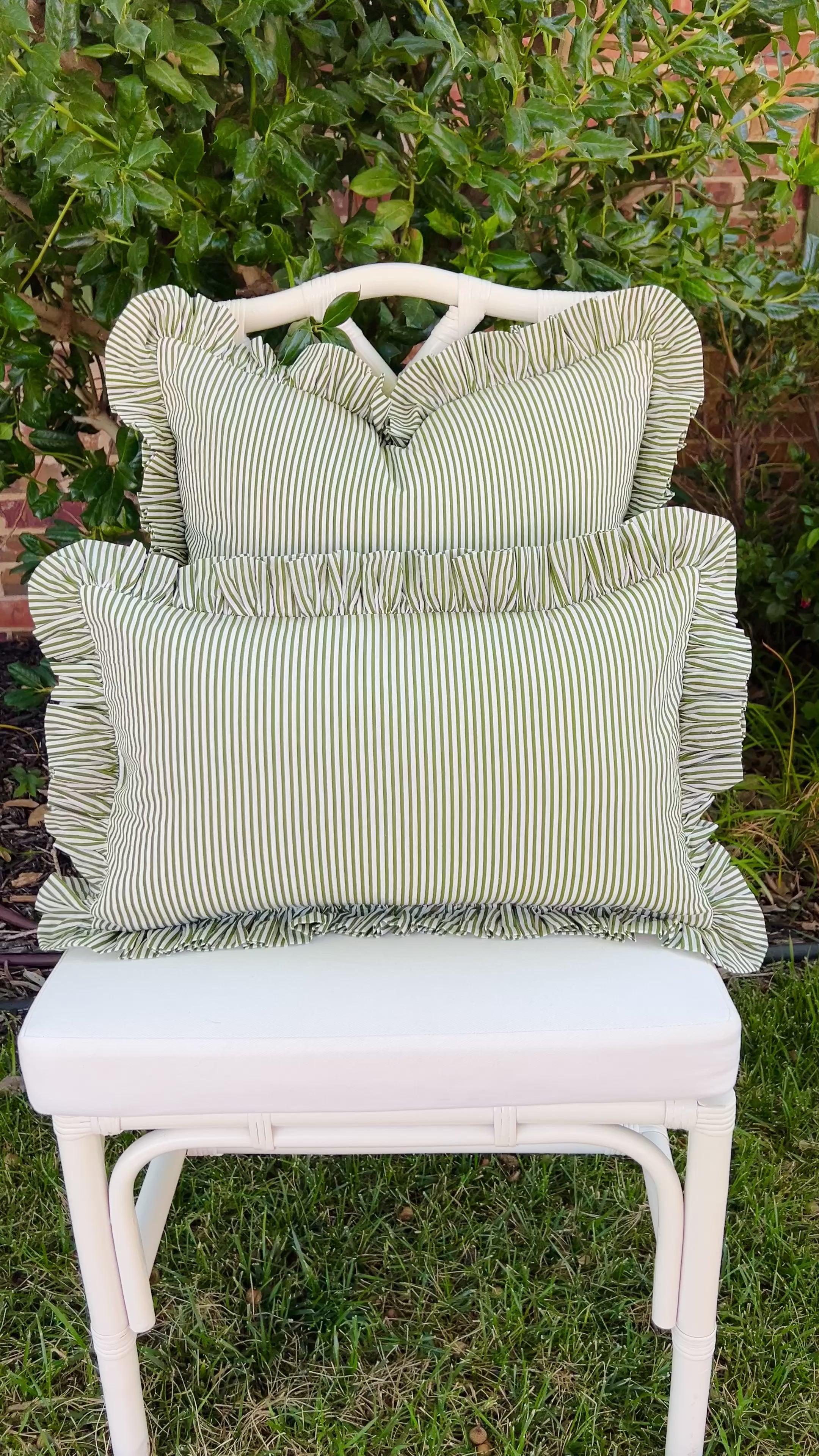 Green and white striped pillow cover with ruffle trim