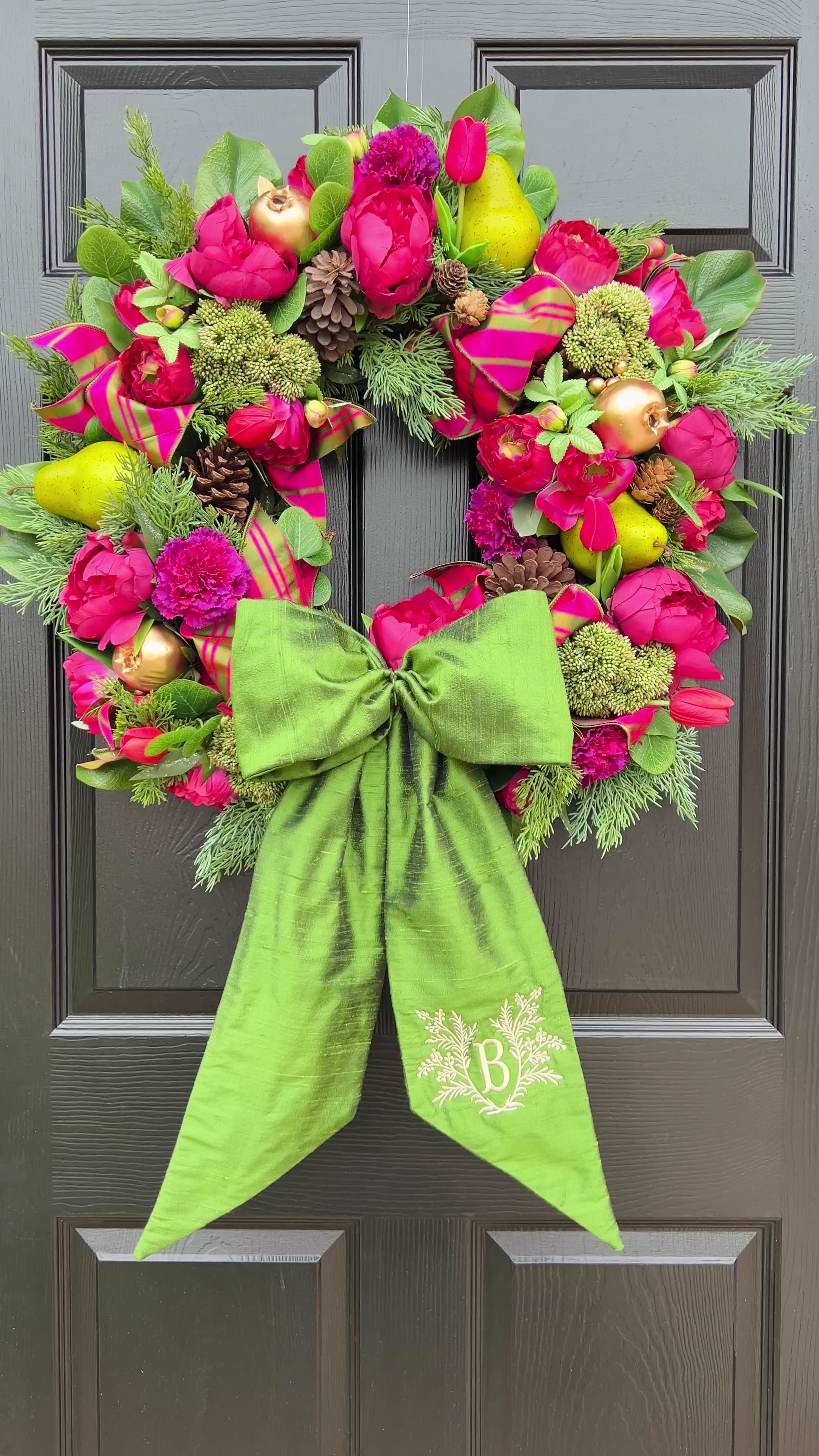 Lush fuchsia and green floral and fruit winter wreath