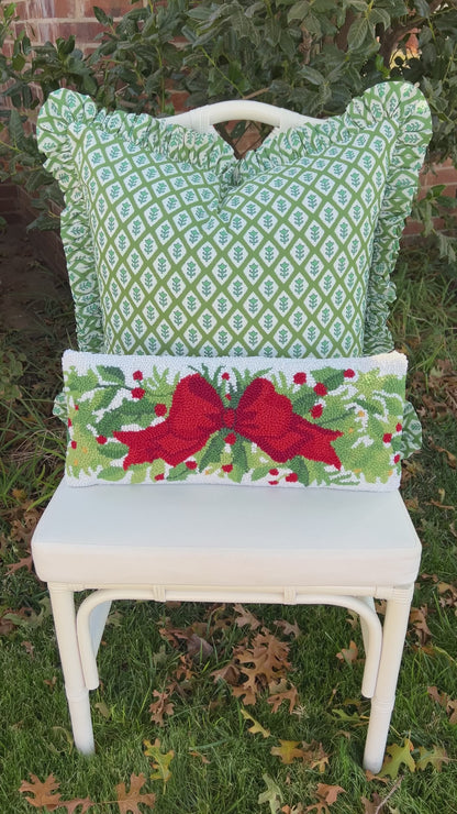Red bow and greenery hand hooked lumbar pillow