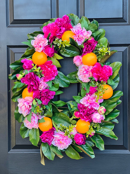 The “Mitzi” pink peony and orange wreath