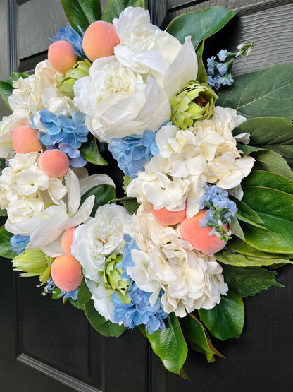 Southern magnolia, peach, and blue hydrangea Summer wreath