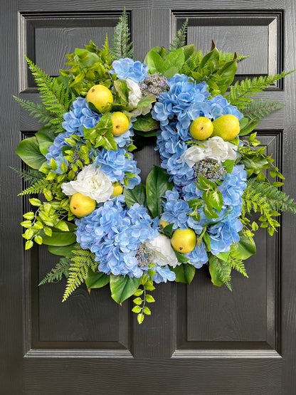 The “Fern” blue hydrangea, pear, and white peony wreath