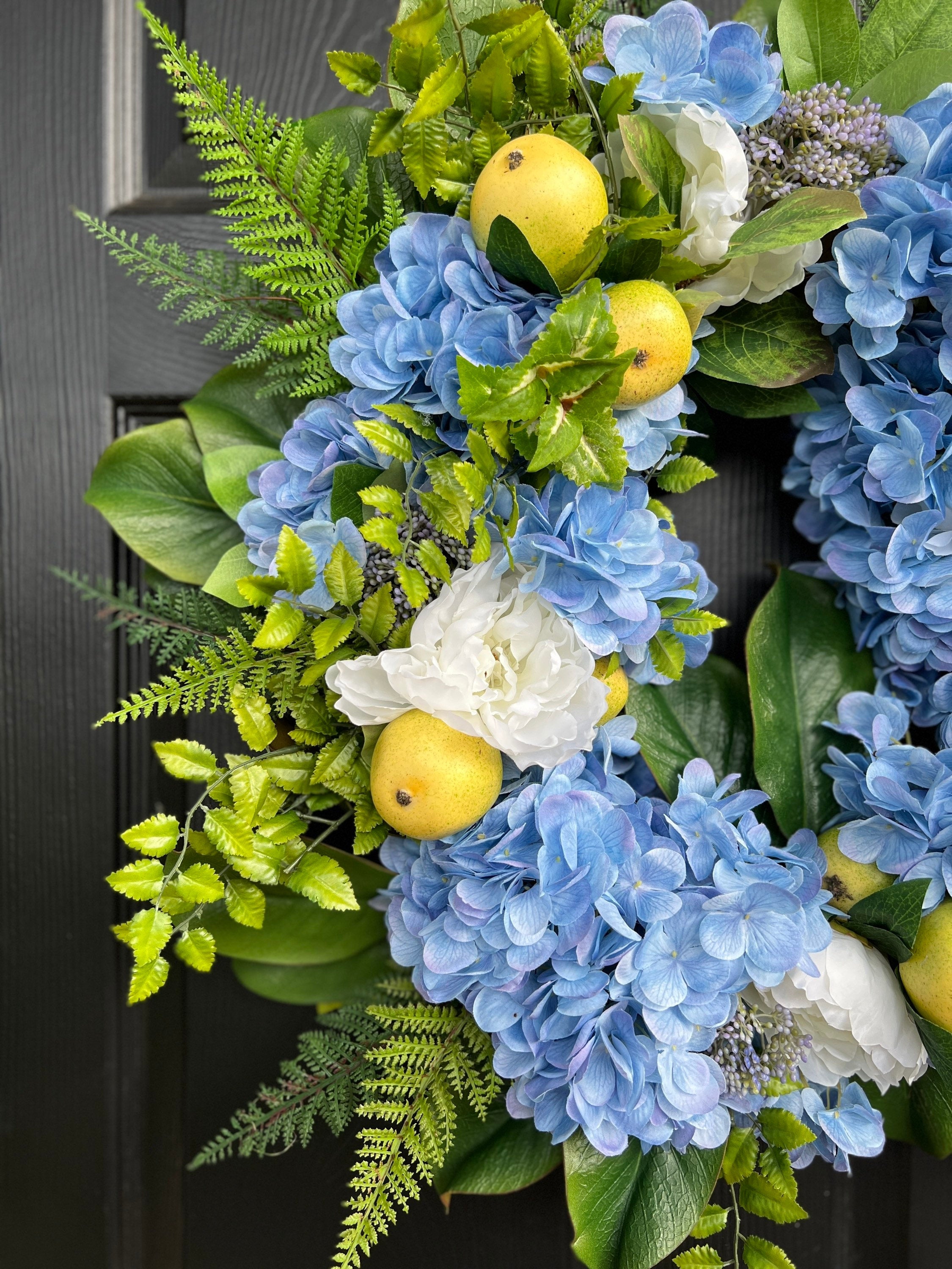 The “Fern” blue hydrangea, pear, and white peony wreath