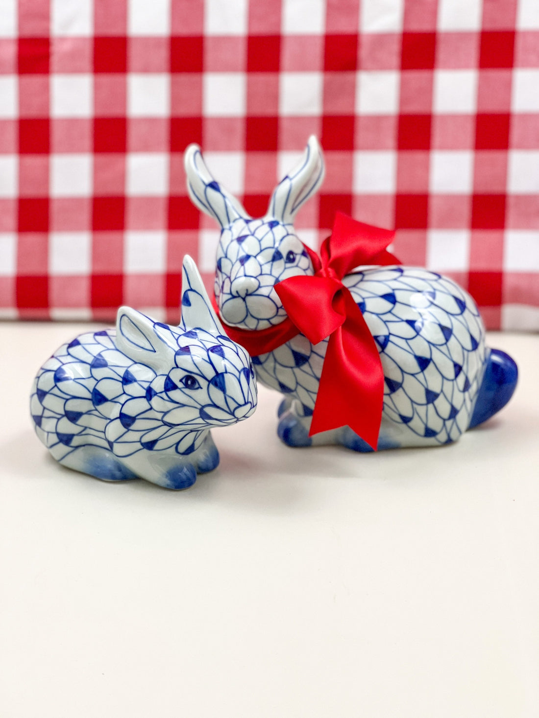 Blue and white fishnet bunny figurine pair