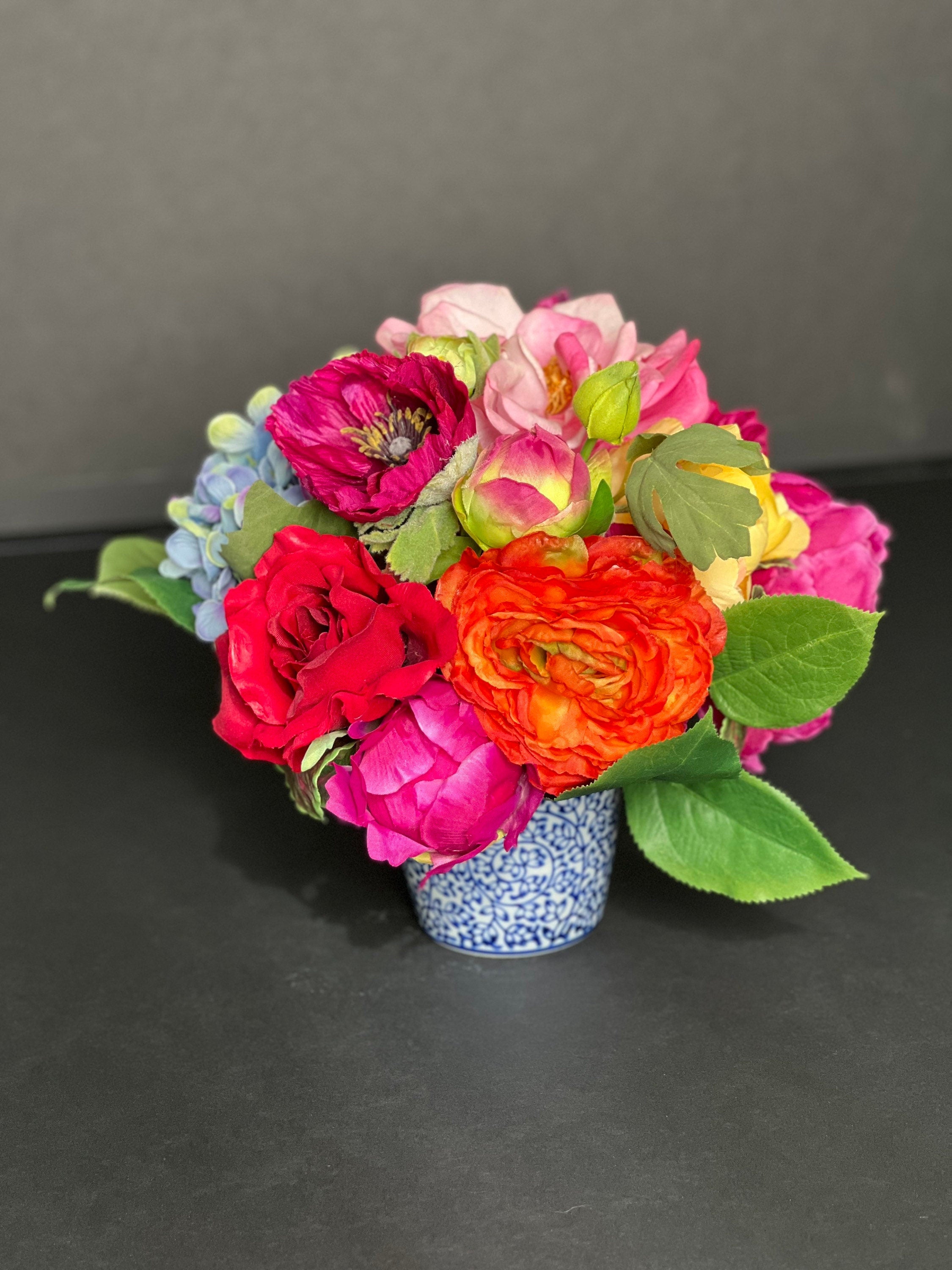 Petite faux floral arrangement in blue and white chinoiserie pot