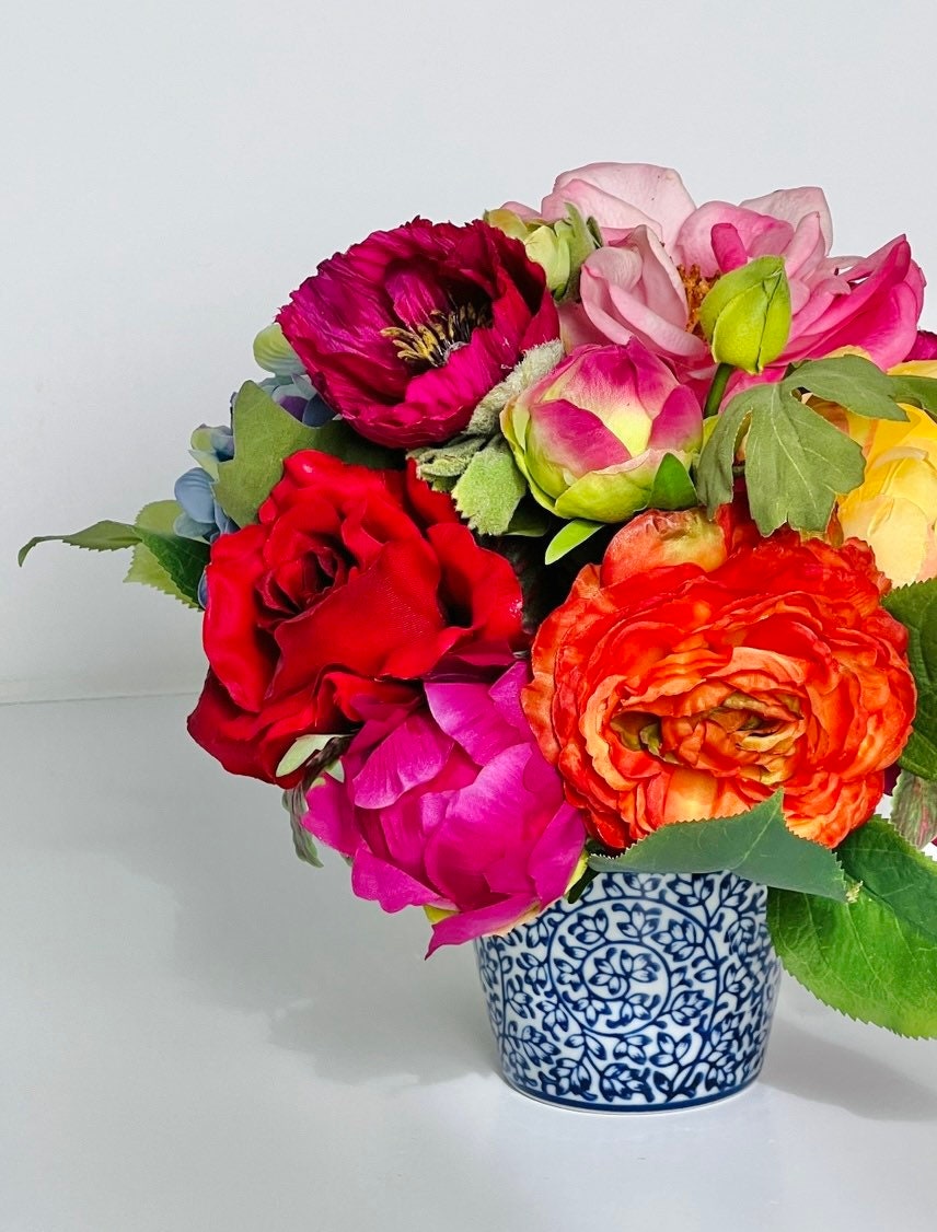 Petite faux floral arrangement in blue and white chinoiserie pot