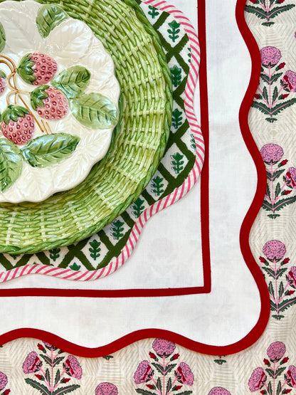 Green block print scalloped placemats with pink and white striped piping, set of 4