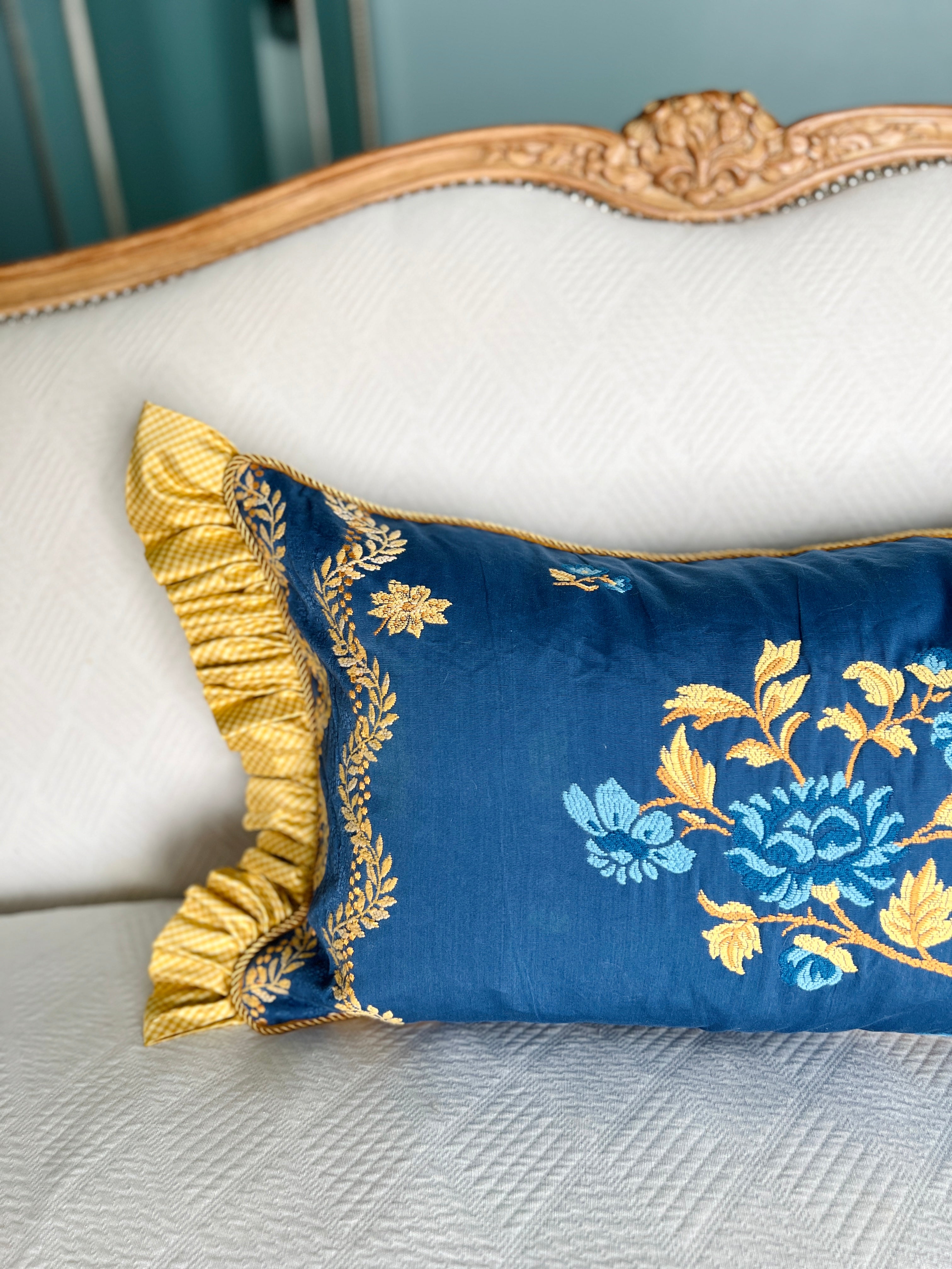Blue and yellow embroidered pillow cover with silk ruffle trim