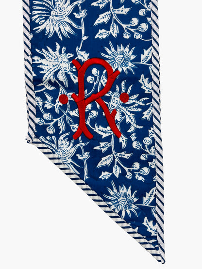 Blue and white block print wreath sash with contrast striped piping, monogram available
