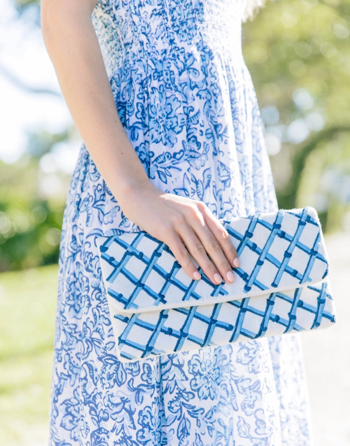 Embroidered linen clutch in blue and white trellis