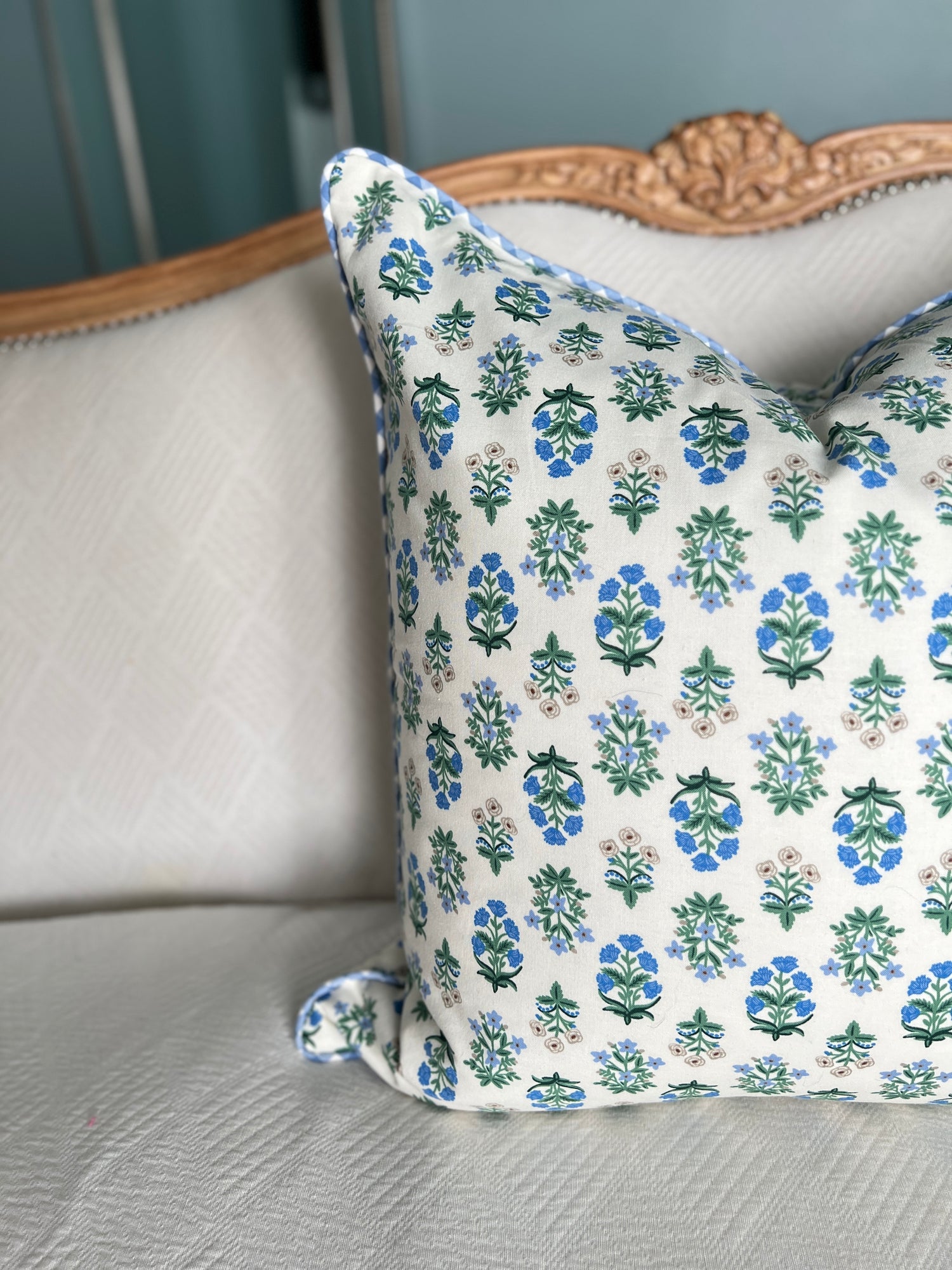 Blue, white, and green block print floral pillow cover with gingham cord